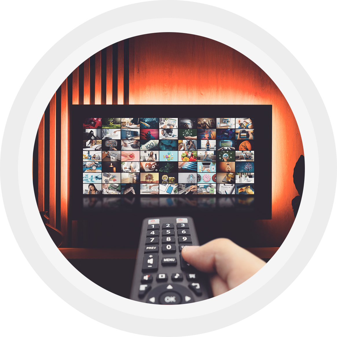 A person holding a remote control pointed at a TV screen displaying a collage of images.