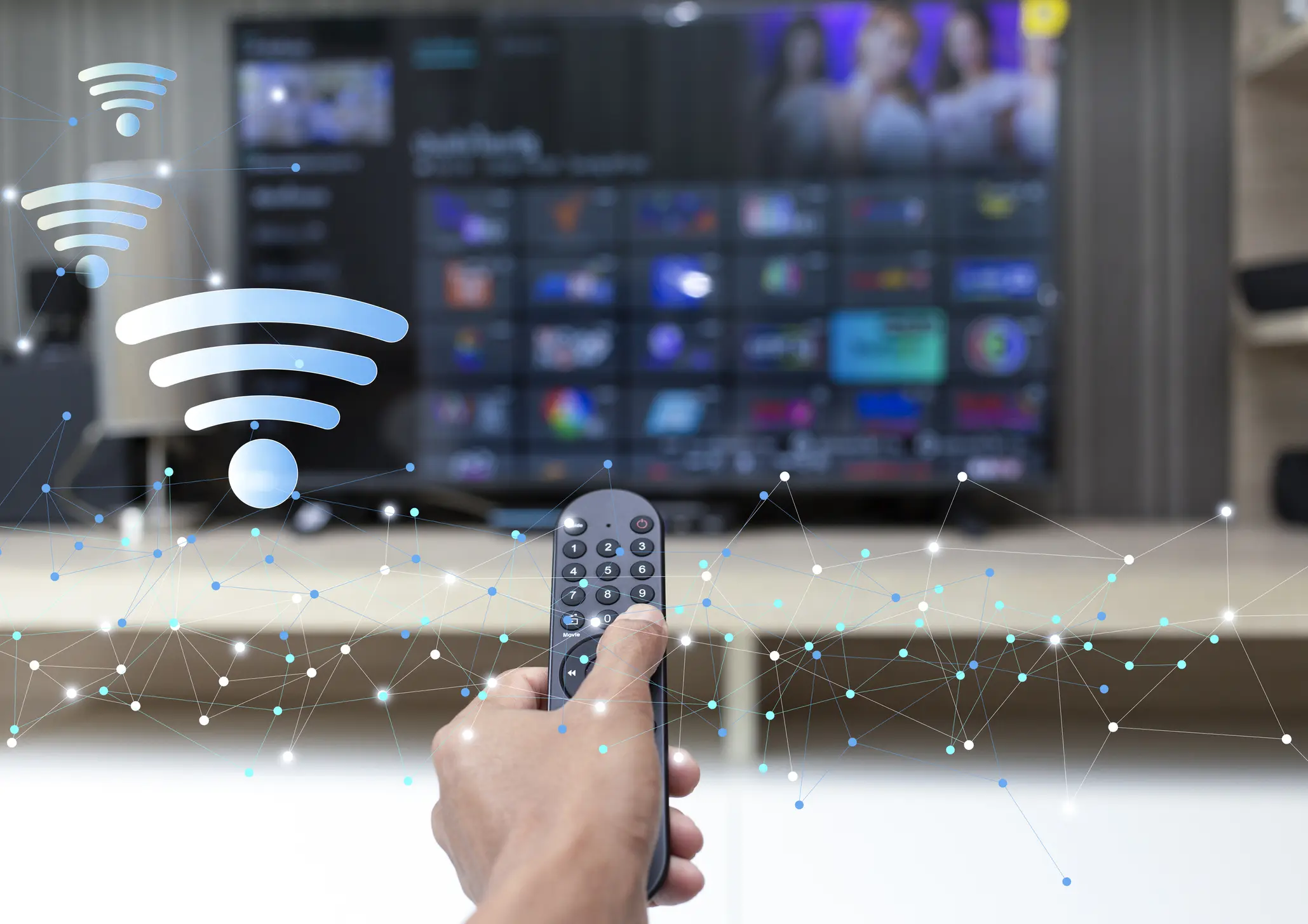 Hand holding remote control pointing at TV with Wi-Fi symbol.