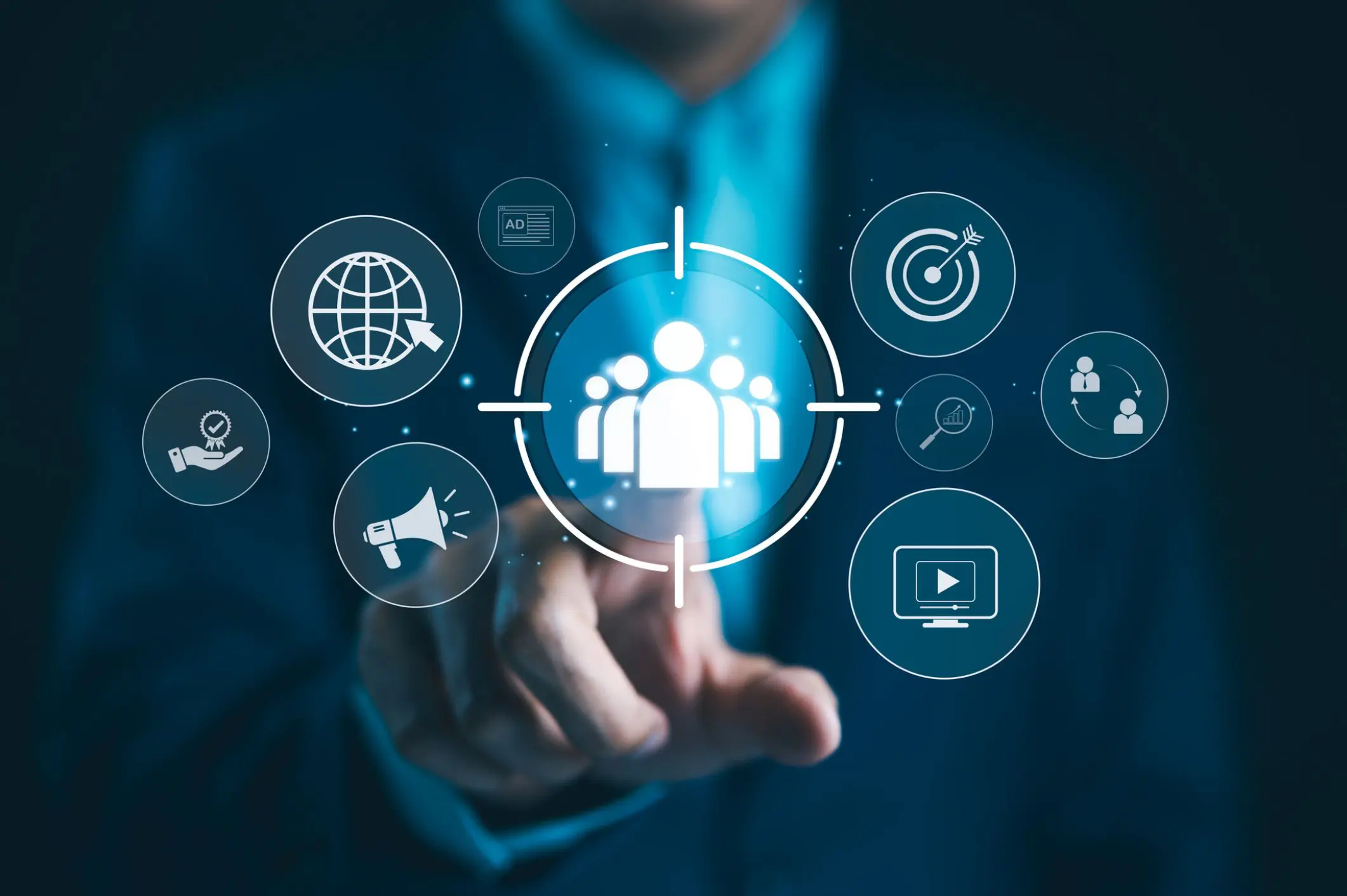 A businessman pointing at a digital icon of a group of people surrounded by various technology icons.